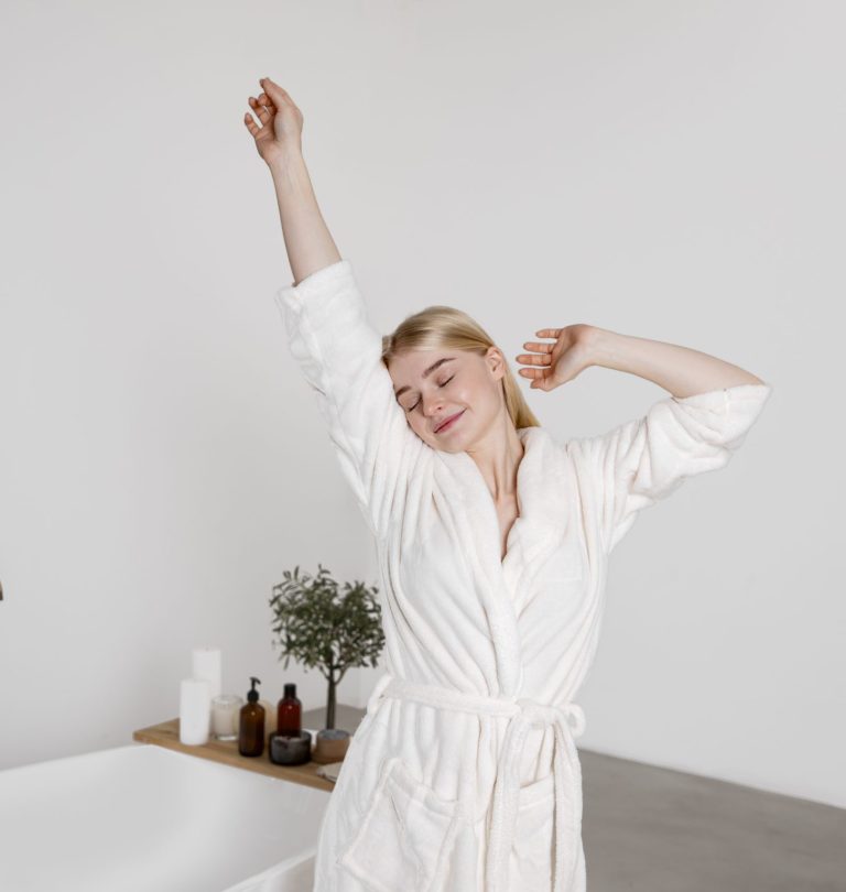 medium-shot-smiley-woman-with-bathrobe